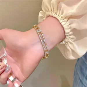 Close-up of 18k gold-plated zircon oval bracelet on woman's wrist