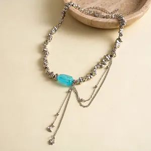 Detailweergave van de onregelmatige zilveren kralenketting met maan- en sterbedeltjes