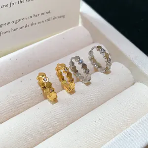 Detail view of 18k gold plated honeycomb hoop earrings with zircons in a jewelry box