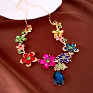 Close-up of elegant colorful floral rhinestone necklace featuring a large blue teardrop pendant
