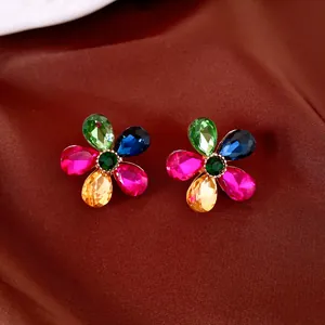 Close-up of colorful crystal flower earrings with vibrant water-drop shaped petals.