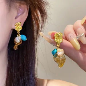 Detailed view of retro Maillard style earrings with stones and leaf tassels