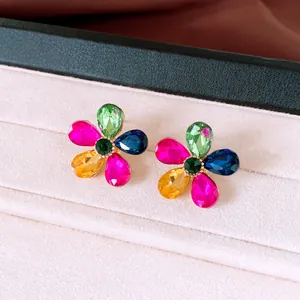 Macro detail of colorful flower stud earrings with vibrant teardrop crystal petals.