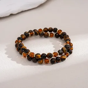 Close-up detail of vintage tiger eye and amber glass beaded bracelet set
