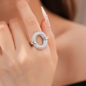 Detailed macro view of a silver-toned oval open-work ring with paved cubic zirconia stones