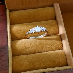 Close-up of a silver adjustable ring with a cluster of sparkling round zircons