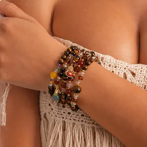 Close-up detail of a vintage tiger eye and glass beaded multi-layer bracelet for women