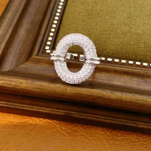 Macro view of a silver-toned open ring featuring an oval pavé-set zircon hollow design