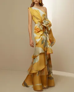 Elegant one-shoulder floral maxi dress with oversized flower detail in yellow.
