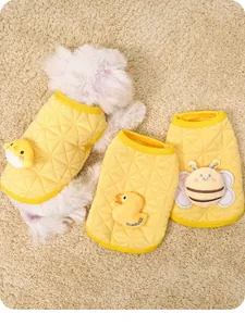 Detailed view of quilted yellow puppy sweatshirts featuring cute 3D chick and bee patches