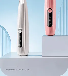 Close-up of pink and white pet hair trimmers with digital displays on platforms.