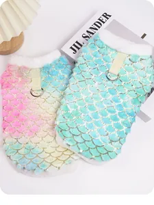 Close-up detail of two fluffy mermaid scale pet vests featuring soft gradient colors and D-rings