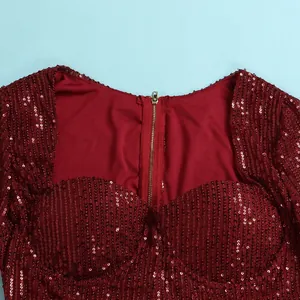 Detailed view of burgundy sequined dress featuring a golden metal back zipper
