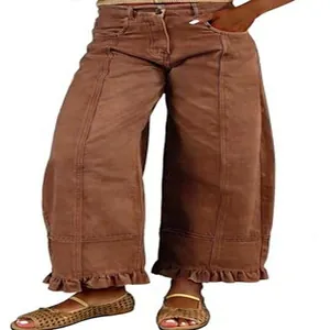 Close-up showing the vintage brown wide-leg jeans with ruffle hem and panel stitching