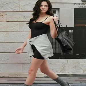 Sexy black camisole tank top with built-in bra for women walking in urban street