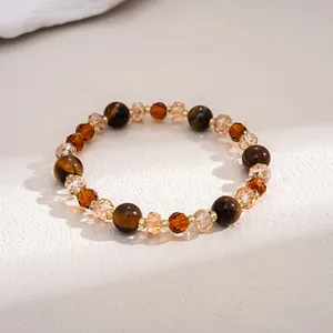 Detailed view of vintage tiger's eye and amber glass beaded bracelet for women