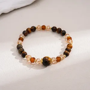 Macro view showing the natural texture of tiger eye stones and faceted amber beads