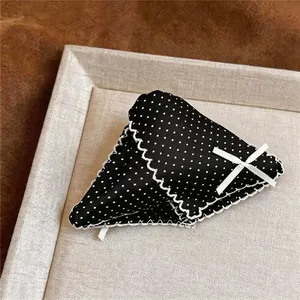 Elegant black polka dot hair claw clip with white lace trim and ribbon bow detail