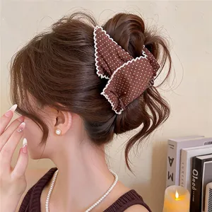Elegant brown polka dot hair claw clip with white lace trim and bow design for women