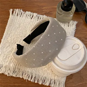 Close-up of a chic Korean style beige fabric headband with delicate white star patterns