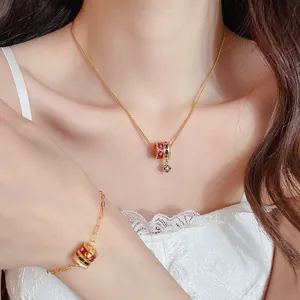 Nahaufnahme eines luxuriösen 24K vergoldeten Halsketten- und Armbandsets mit Emaille