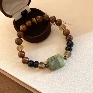 Detailopname van een houten kralenarmband in nieuwe Chinese stijl met groene jade steen