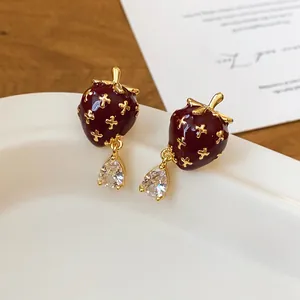 Close-up detail of vintage style strawberry earrings with clear zircon teardrops