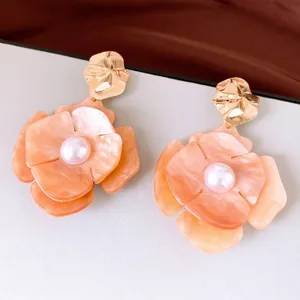 Elegant peach pearl acrylic flower stud earrings with hammered gold metal finish