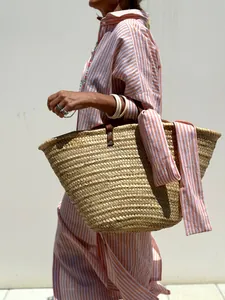 Detailed view of women's stylish orange striped lapel collar shirt dress with straw basket bag