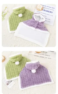 Close-up showing the soft plush texture of checkered pet hooded cloaks in green and purple