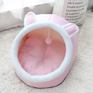 Soft pink plush cat bed featuring cute rabbit ears and an integrated hanging toy ball