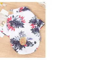 Detail view of Hawaiian-style pet shirt with vibrant pineapple and leaf prints