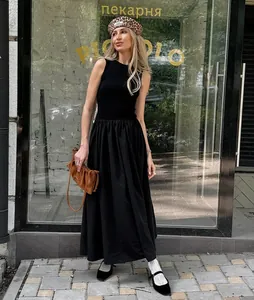 Vintage Hepburn style sleeveless black knitted maxi dress shown in a lifestyle setting.