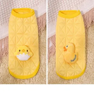 Close-up of yellow quilted winter pet vest with cute cartoon duck and chick patches