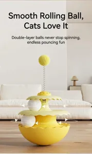 Detail of yellow three-tier cat tumbler toy featuring rolling balls and spring pom-pom