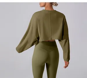 Back view detail of women's olive green loose cropped long sleeve yoga sports top