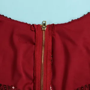 Macro view showing the durable golden metal zipper detail on a red sequin bodycon dress