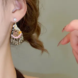 Detailed close-up shot showing the intricate vintage Bohemian crystal drop earrings on an ear