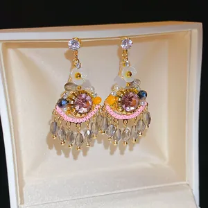 Bohemian vintage crystal drop earrings with floral accents and beaded fringe detail.