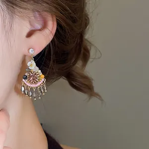 Close-up detail of bohemian vintage style dangle earrings featuring crystals and beads