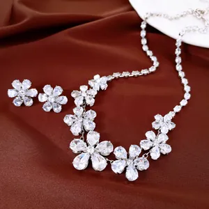 Primer plano de un conjunto de collar y pendientes de flores de circón brillante para mujer