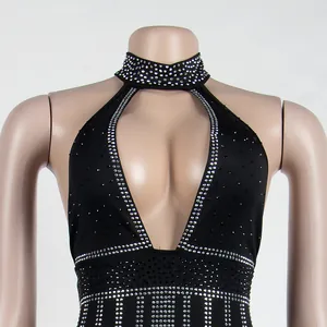 Detail of black halter dress with intricate rhinestone patterns and plunging neckline