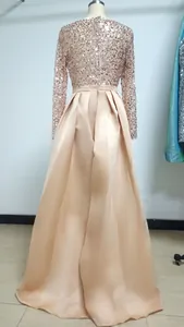 Back view detail of elegant rose gold sequin top and satin long evening gown for formal events