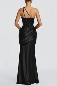 Back detail of a black satin one-shoulder dress with draped corset and fishtail hem.