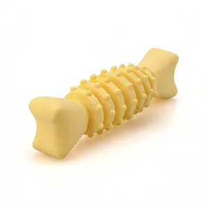 Macro view of durable yellow TPR dog chew bone toy with specialized cleaning bumps