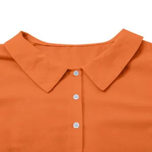 Macro detail view of an orange cotton linen shirt collar with three white buttons