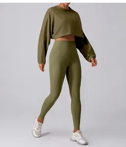 Detail view of stylish olive green crop top sweatshirt and high waisted yoga leggings set