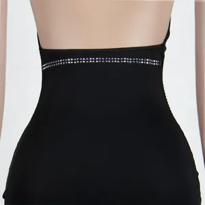 Close-up of sparkling rhinestone waistband on sexy black halter neck evening dress