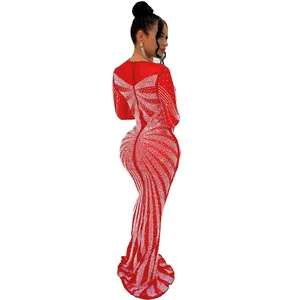 Detailed view of red rhinestone floor-length evening gown from side profile