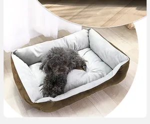 Close-up of a soft plush rectangular dog bed showing grey fleece lining and brown fabric.